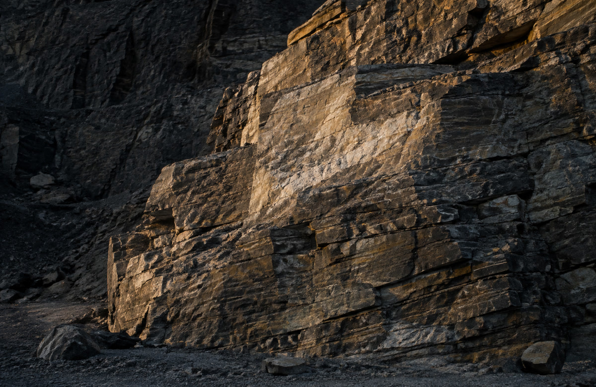 Layered natural quartzite rock face in warm late-afternoon light